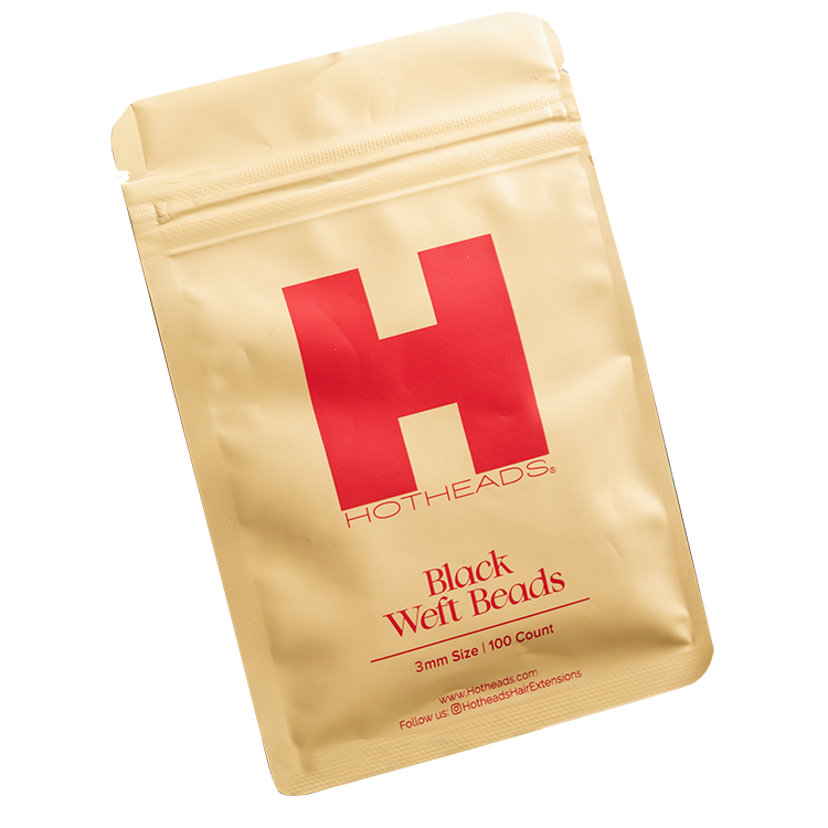 A packet of black weft beads by Hotheads, designed for hair extensions, against a white background.