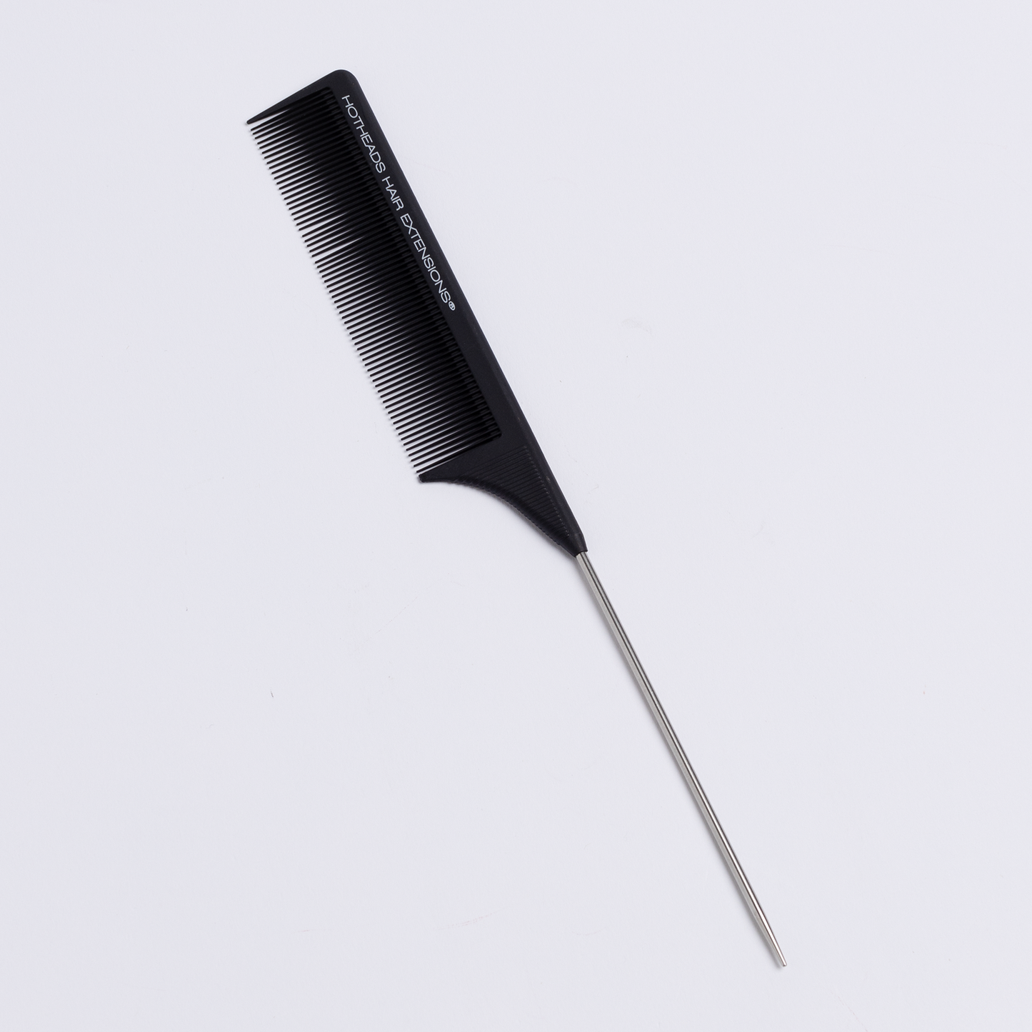A rattail comb with a black handle is displayed on a white surface.