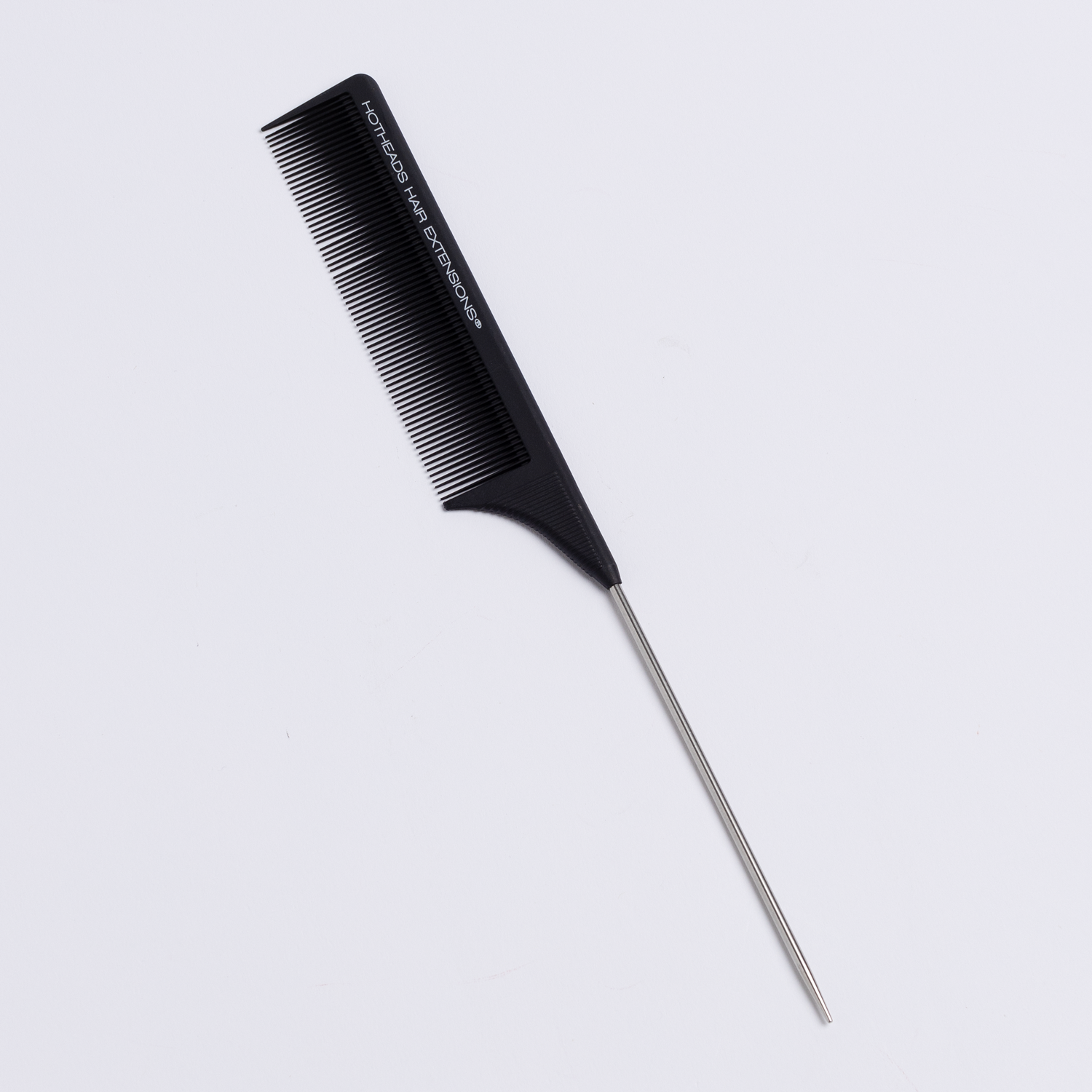 A rattail comb with a black handle is displayed on a white surface.