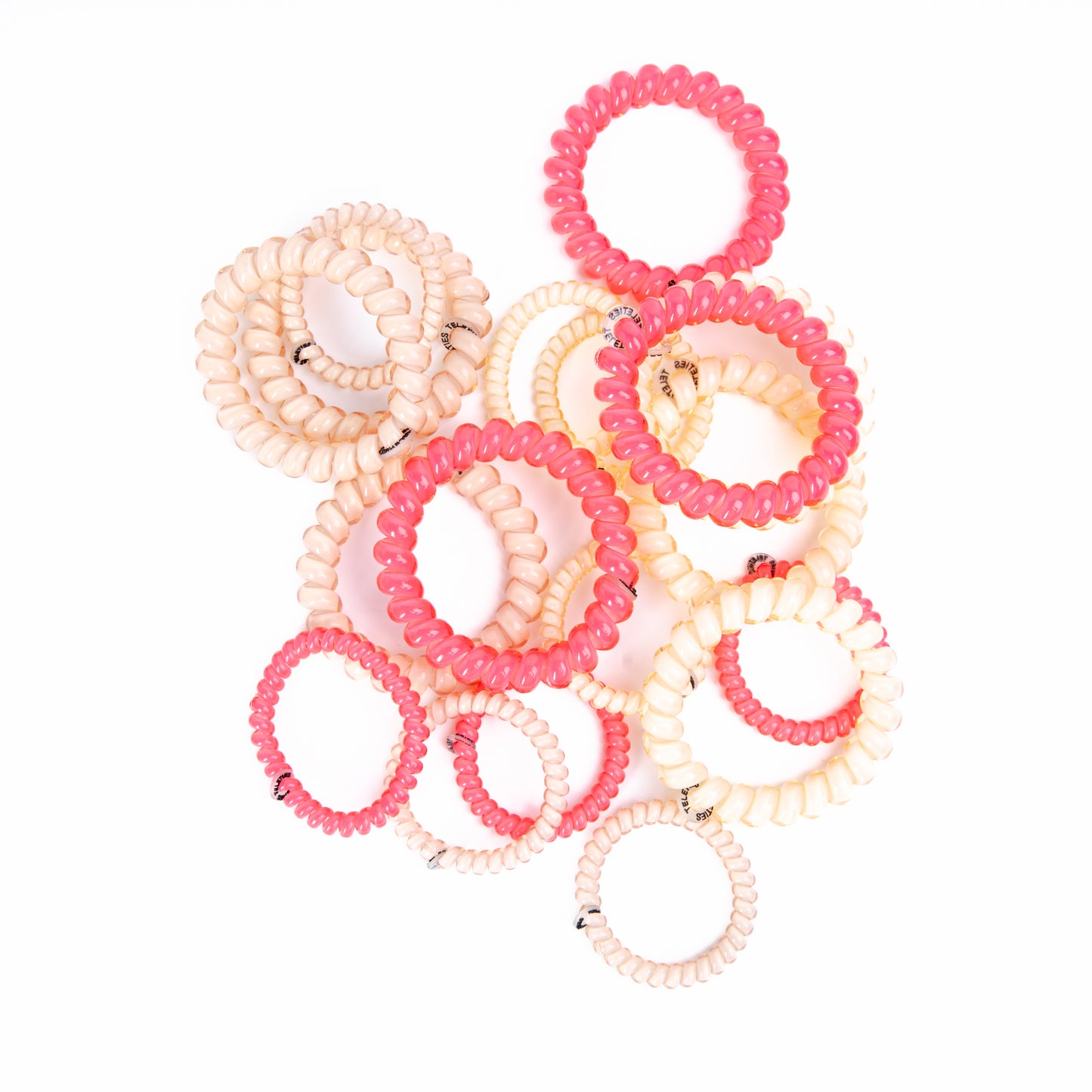 A colorful assortment of pink and white teleties hair ties stacked together.