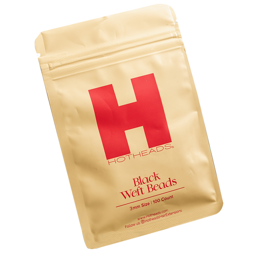 A packet of black weft beads by Hotheads, designed for hair extensions, against a white background.