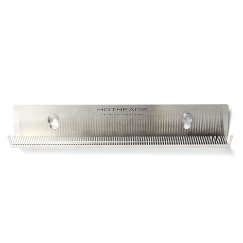 A Hotheads sleek metal comb with an integrated holder.